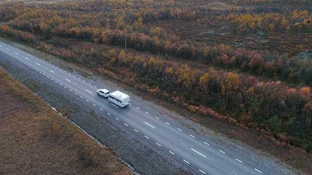 50fps drone footgage Car Camping Caravan driving road lake Swedish Lapland Sunny fall colors Abisko National Park Sweden