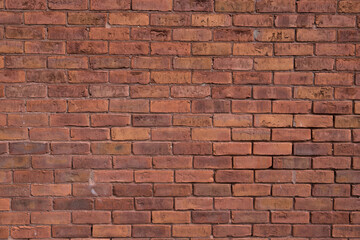 Weathered red brick wall background. Old stone wall with gaps in the mortar