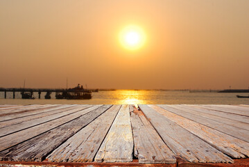 Fototapeta na wymiar Wooden platform beside tropical sunset sea