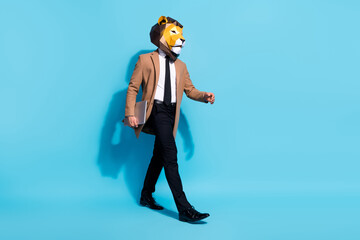 Full body profile side photo of freak bizarre anonym guy lion mask go hold netbook isolated over...