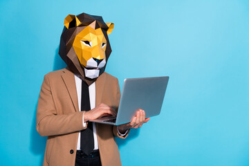 Photo of smart marketer guy wear lion mask use netbook app typing message colleagues isolated over...