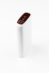 white power bank for charging smartphones and various digital devices on a white background close-up