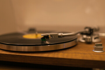 Vintage vinyl records player at home with a green plant