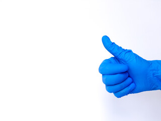 Hand sign thumb up, with blue latex glove. Isolated in white background. Space for text