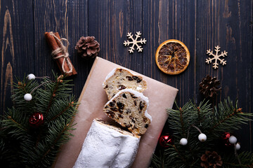 Obraz na płótnie Canvas Dresdner Stollen is a Traditional German Cake with raisins on wooden background. Fruit cake for the Holiday.