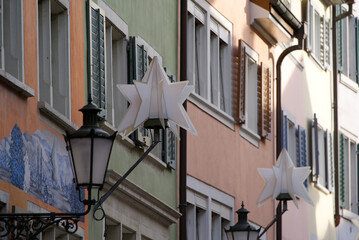 Fototapeta na wymiar Close-up of Christmas lights in star shape at the old town of Zürich on a sunny autumn day. Photo taken November 18th, 2021, Zurich, Switzerland.