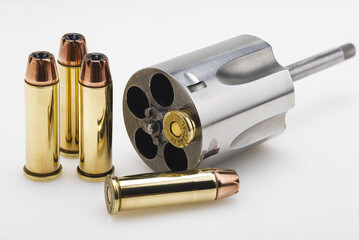 .38 special gun bullets with stainless revolver cylinder on white background