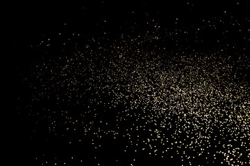 Black festive background. Abstract scattering of gold sparkles on black. Holiday backdrop, selective focus