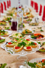 sandwiches with butter and caviar on a large festive table with food