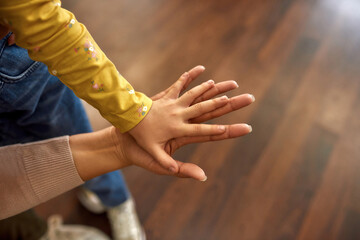Togetherness and support concept. Child placed hand on mother's