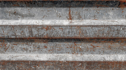 Texture of old rusty grungy metal sheet. Uneven aged rough bumpy surface. Corrugated painted wall of smudged iron. Rusted hard pitted retro garage door. Vintage dirty destroyed roof for grunge design