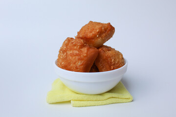 indonesian sweet fried bread with sesame seed on top, called Odading or Bolang-Baling. Served on a bowl, isolated on background