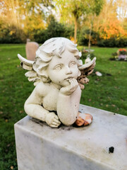 little old angel on a tombstone in the cemetery