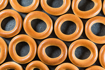 Ukrainian, Russian and Belarusian traditional bakery food fresh delicious bread rings (bagels, sushki or baranki), isolated on dark background.