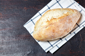 Bread on a wooden background. Fresh bakery on dark kitchen table
