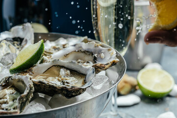 Oyster dinner with champagne in restaurant. Fresh Oysters with lime, lemon and ice. Restaurant menu, dieting, cookbook recipe © Надія Коваль