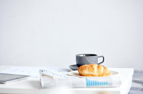 Still life of newspaper and breakfast on table