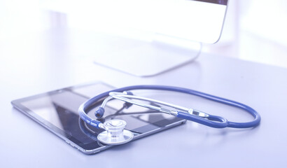 Medical equipment: blue stethoscope and tablet on white background. Medical equipment