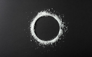 Salt is scattered on a black background.