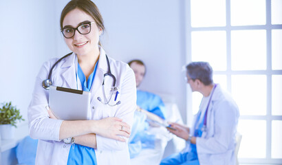 Fototapeta premium Female doctor using tablet computer in hospital lobby