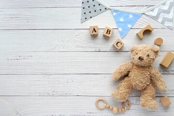 Childhood, kids toys, nursery, kindergarten concept, flat lay composition with wooden and soft toys, flag banner, space for text or product.