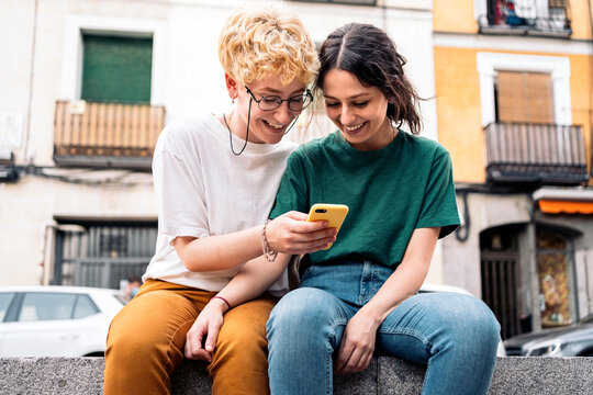 Lesbian couple using smartphone