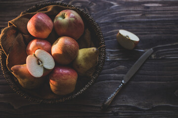 still life apples in a wicker basket on a wooden table