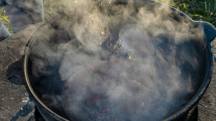 Mulled wine in a large cauldron. Mulled wine is cooked in a large pot. Vitamins in the traditional festival.