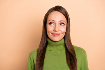 Fototapeta premium Photo of young lovely lady wondering look empty space wear green sweater isolated on beige color background