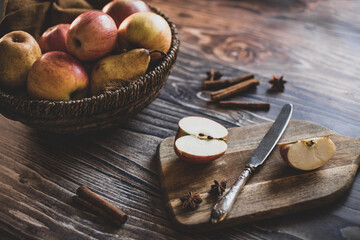 still life apples in a wicker basket on a wooden table