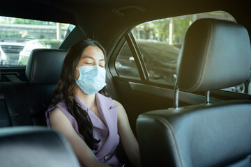 Beautiful Asian businesswoman wear a hygiene protective face mask taking a back seat.