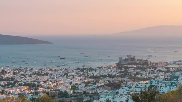 Time lapse: scenic view from high point of Turkey Bodrum resort town, sea port full of boats, ships and yachts, ancient Castle of St. Peter, seashore of Aegean sea during sunset