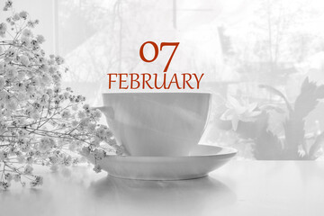 calendar date on light background with porcelain white tea pair and white gypsophila with copy...