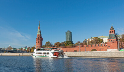 Fototapeta premium Pleasure motor ship on the Moskva River near the walls of the Kremlin embankment in Moscow