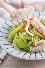 Stir-fried neritic squid with celery. Delicious homemade seafood with vegetable meal.