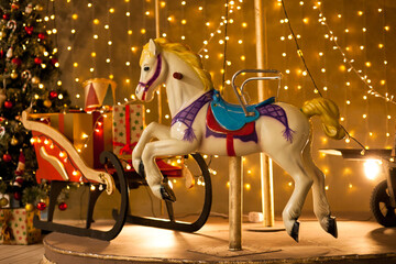 Festive merry go round carousel with a horse and a christmas tree on a christmas market