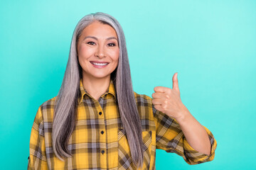 Photo of mature woman show thumbs-up ad approve quality select isolated over teal color background