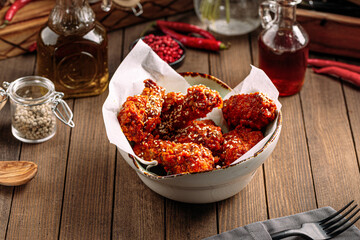 Bowl of spicy buffalo wings snack on wooden background