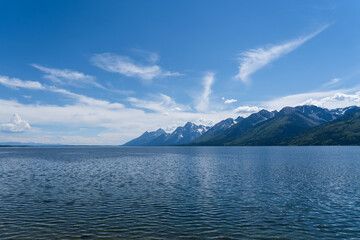 The blue waters of Jackson Lake on a sunny summer day in Grand Teton National Park near Jackson Hole, Wyoming