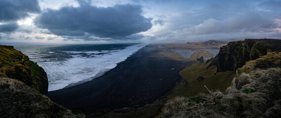 Black sandy beach seen from the cliff at the cape Dyrholaey, the most southern point of Iceland.