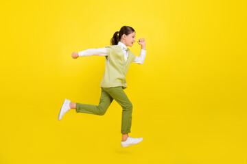 Fototapeta na wymiar Full length body size view of attractive purposeful cheery girl jumping running isolated on vivid yellow color background