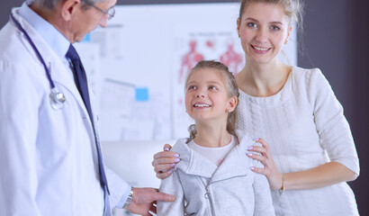 Little girl with her mother at a doctor on consultation