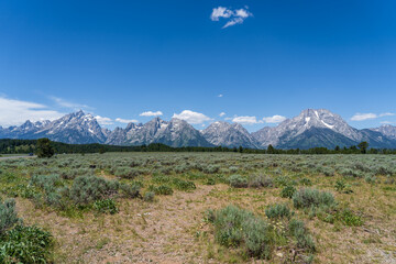 The rocky peaks of the Grand Teton mountain range near in Jackson Hole, Wyoming on a sunny day