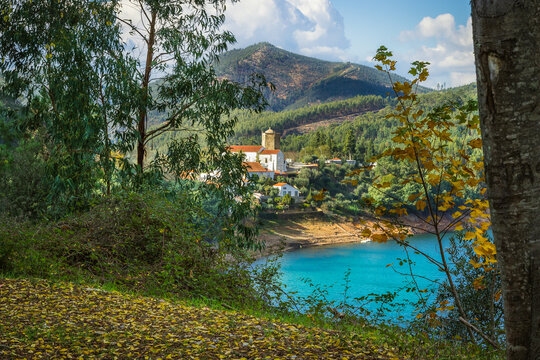 Picturesque village of Dornes in the Zezere river - Portugal. Old church and castle over the river with mountain background