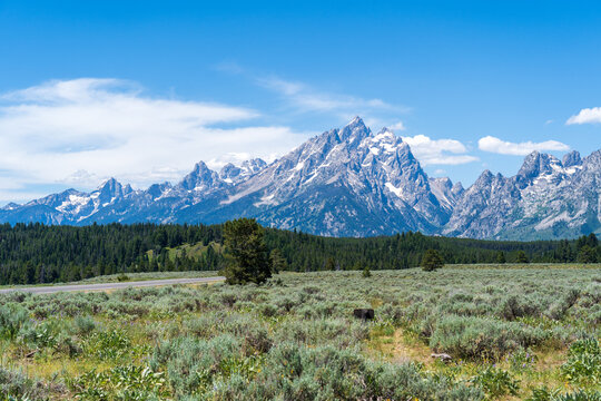 The rocky peaks of the Grand Teton mountain range near in Jackson Hole, Wyoming on a sunny day