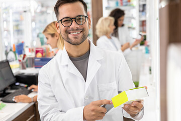 Fototapeta na wymiar Portrait of male pharmacist in drugstore.