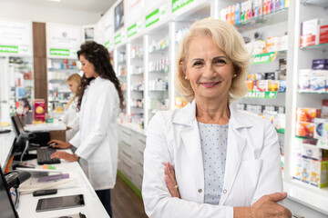 Portrait of senior female pharmacist in drugstore.