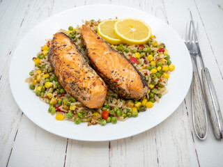 grilled salmon steak with vegetables on white plate