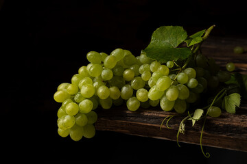 Green grapes on a wooden table
