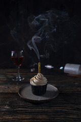 Obraz na płótnie Canvas Festive cupcake alone on a dark wooden table